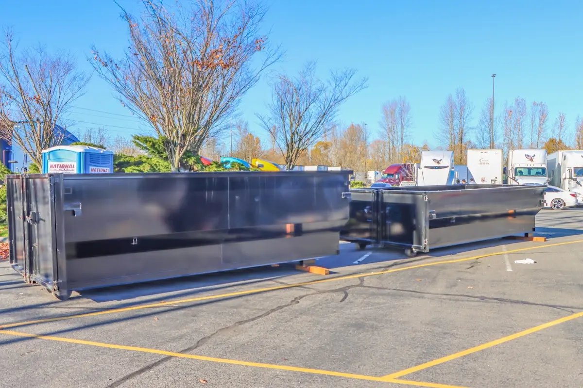 Professional dumpster rental service with roll-off container on residential driveway in Allegan